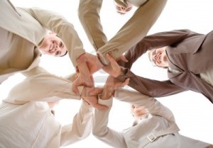 3199990-small-group-of-business-people-joining-hands-low-angle-view